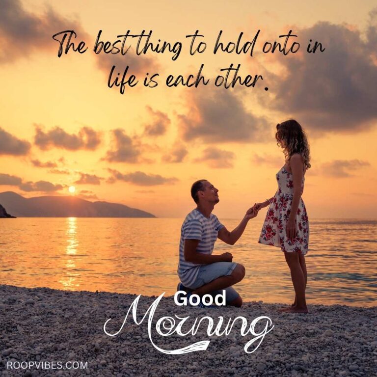 Sunrise At The Sea Shore With A Man Sitting And Holding The Hand Of A Standing Woman, Accompanied By A Good Morning Love Quote