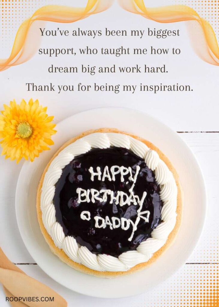 Blueberry-Topped Birthday Cake With White Frosting, Decorated With A Message Saying Happy Birthday Daddy, Placed On A White Table With A Yellow Flower